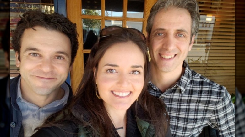 Danica McKellar, Josh Saviano, and Fred Savage posing for a selfie outdoors.