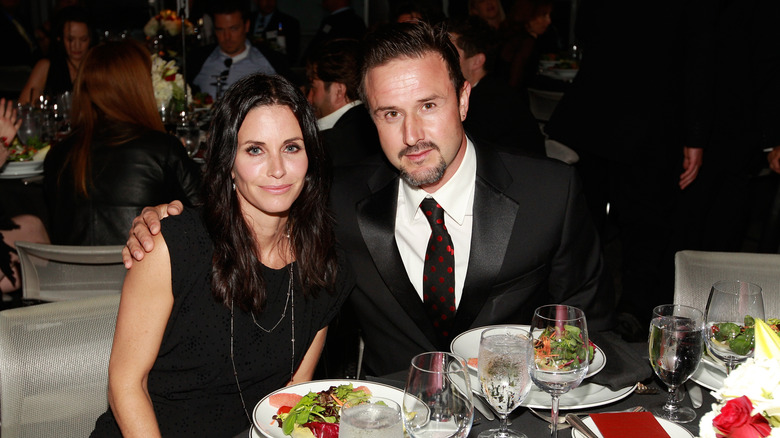 Courteney Cox and David Arquette posing wearing black at a benefit dinner.