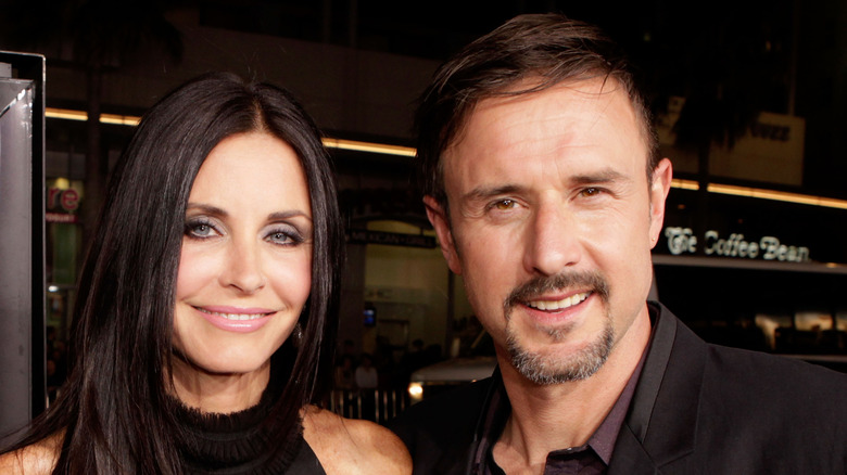 Courteney Cox and David Arquette smiling and posing.
