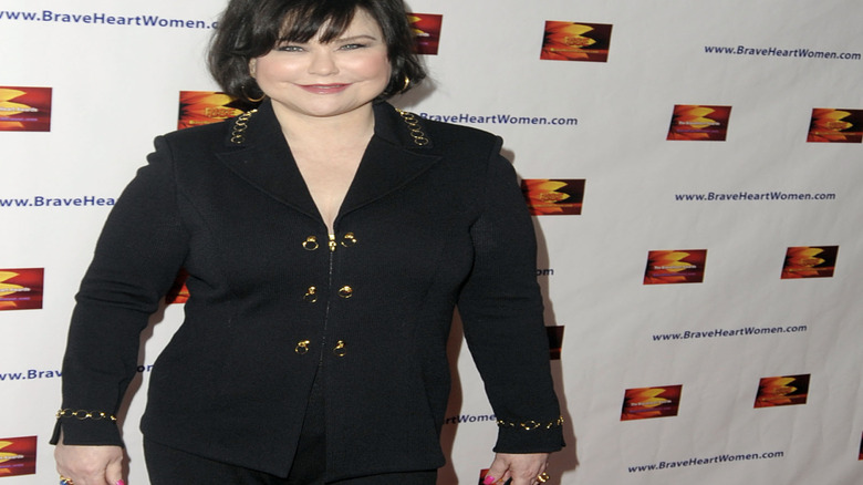 Delta Burke smiling, posing