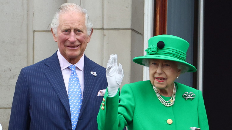 Charles and Elizabeth on the palace balcony, smiling