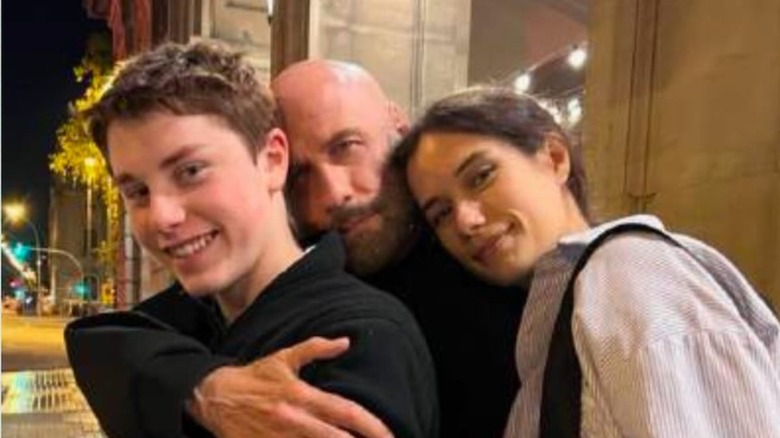 John Travolta hugging his two kids