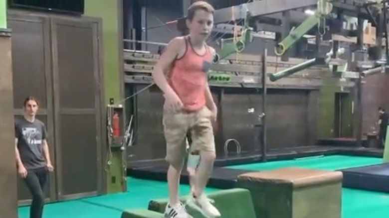 Ben Travolta standing on a box
