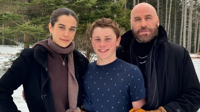 John Travolta and his kids posing for a photo