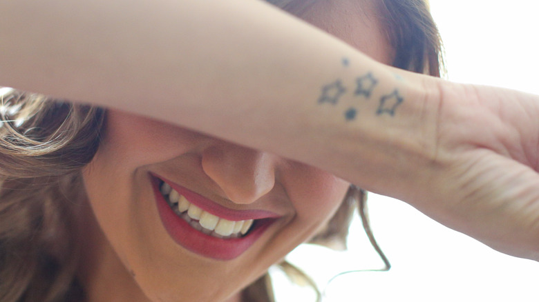 Woman with star tattoos smiling