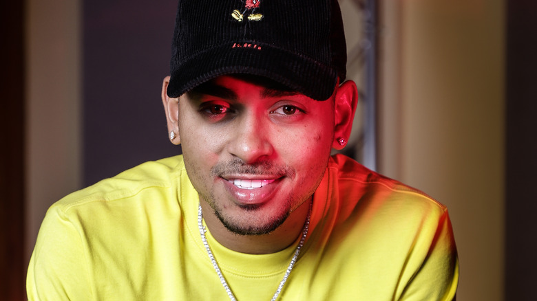 Ozuna wearing a yellow shirt and black hat.