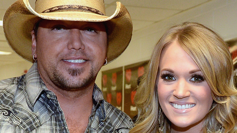 Carrie Underwood and Jason Aldean pose backstage