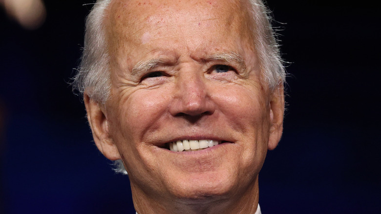President Joe Biden smiling onstage