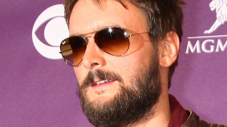 Eric Church posing in sunglasses with facial hair