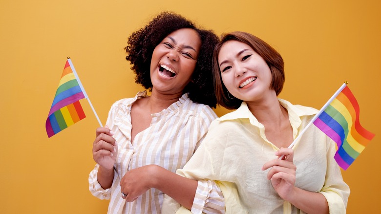 Two women holding pride flags