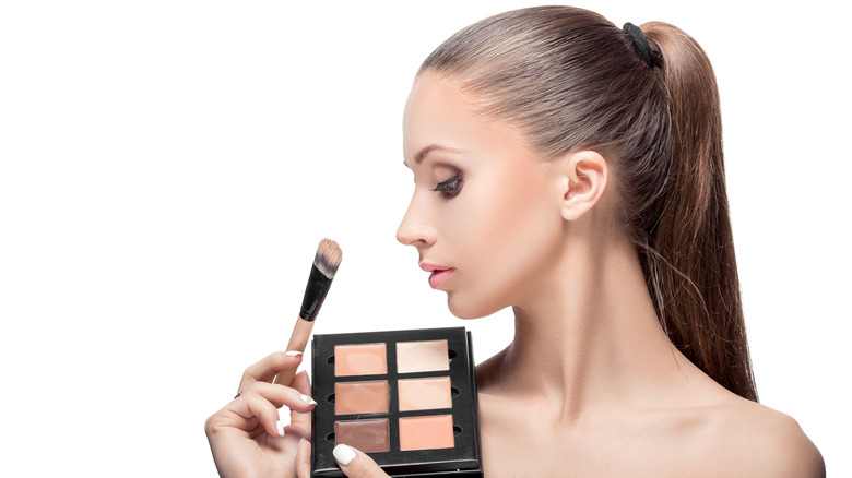 Woman holding contour palette