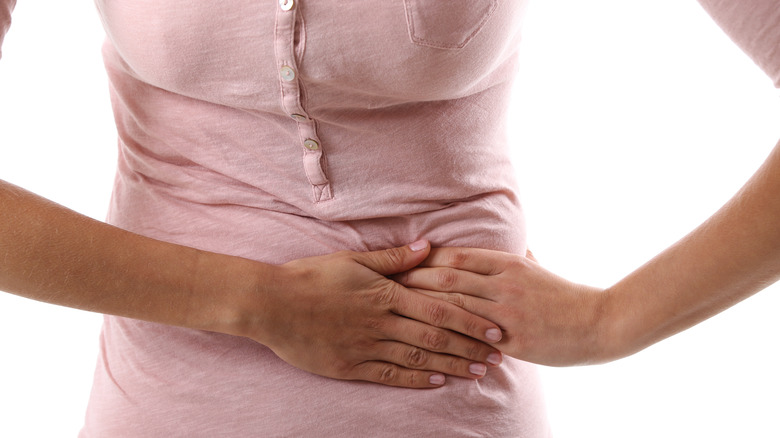 Woman experiencing left abdominal pain