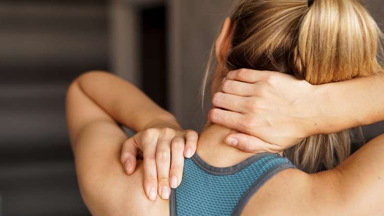 Woman experiencing pain in her neck