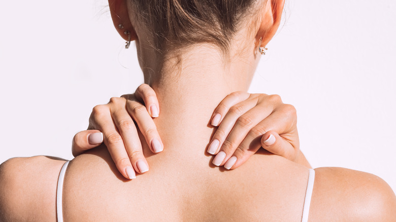 Woman experiencing pain in her neck 