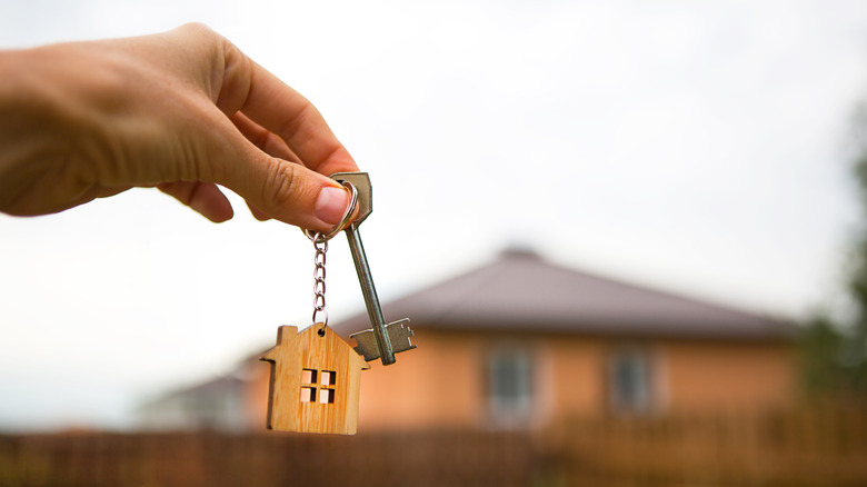 Hand holding keys to new house