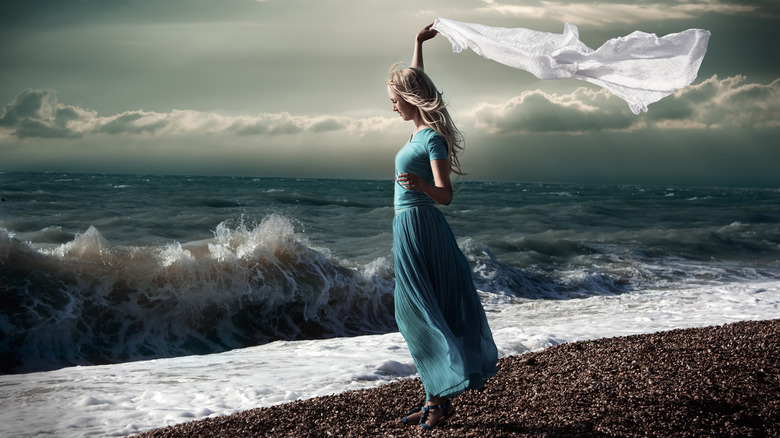 A woman on the beach as a storm rolls in