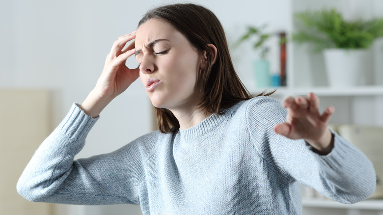 Woman feeling dizzy after standing up 