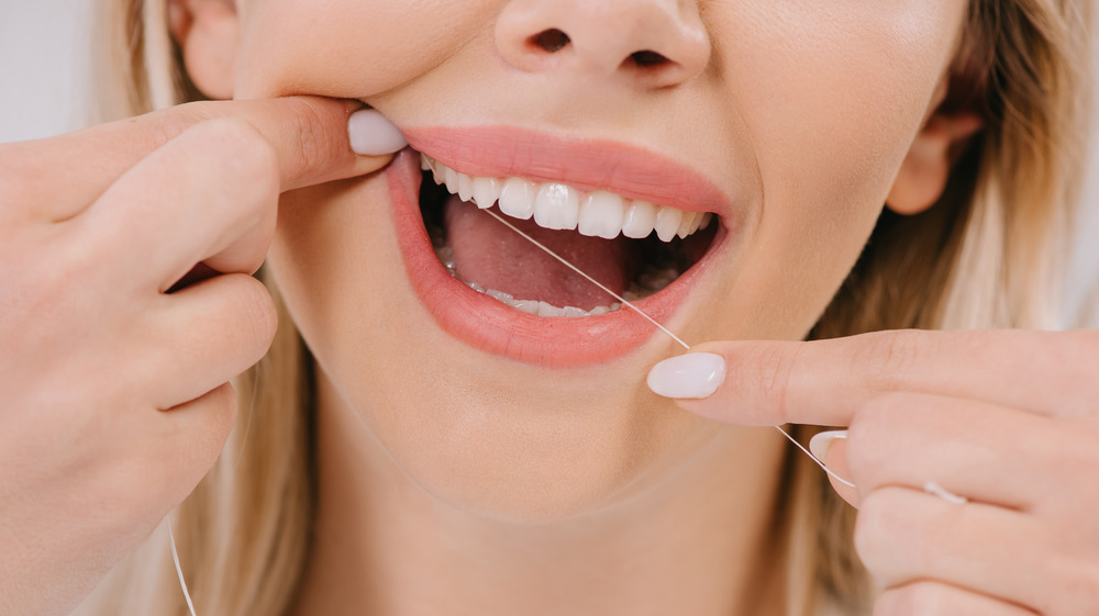 Woman flossing.