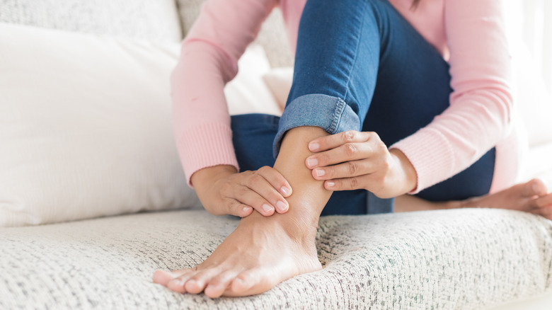 Woman experiencing pain in her left ankle