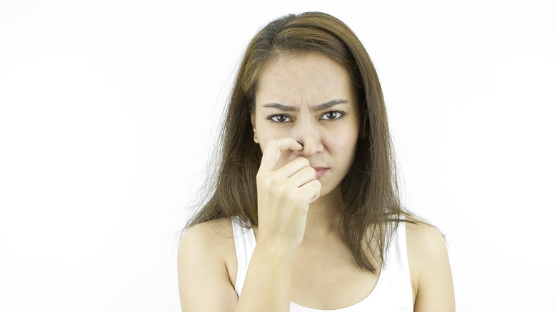 woman itching nose