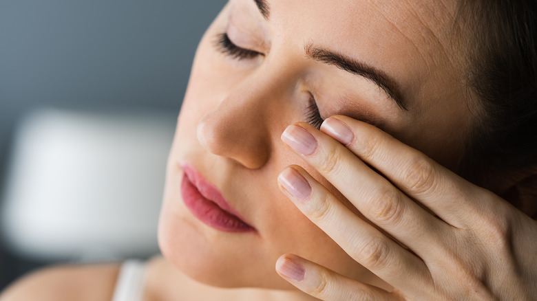 Woman experiencing pain in her eye