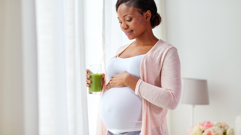 Pregnant woman holding her belly