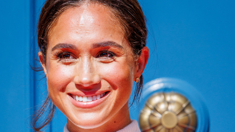 Meghan Markle poses at an event.