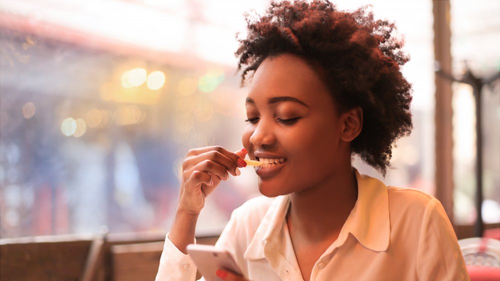 Woman enjoying a salty snack