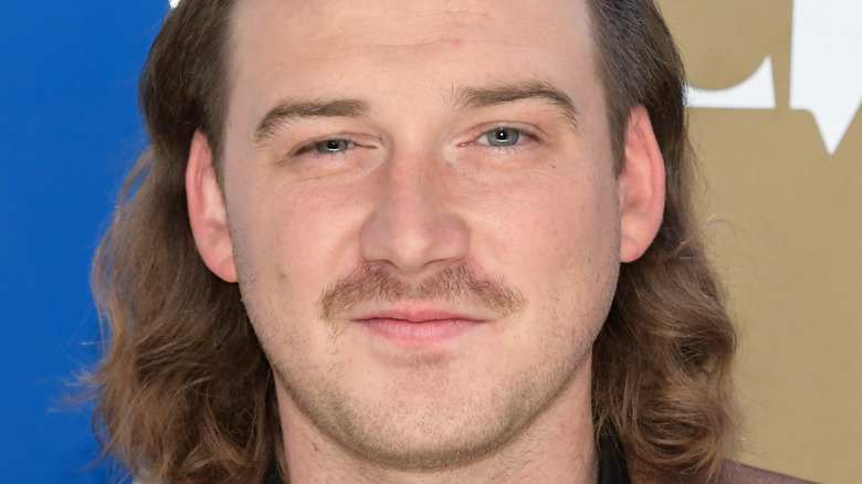 Morgan Wallen grinning with mustache