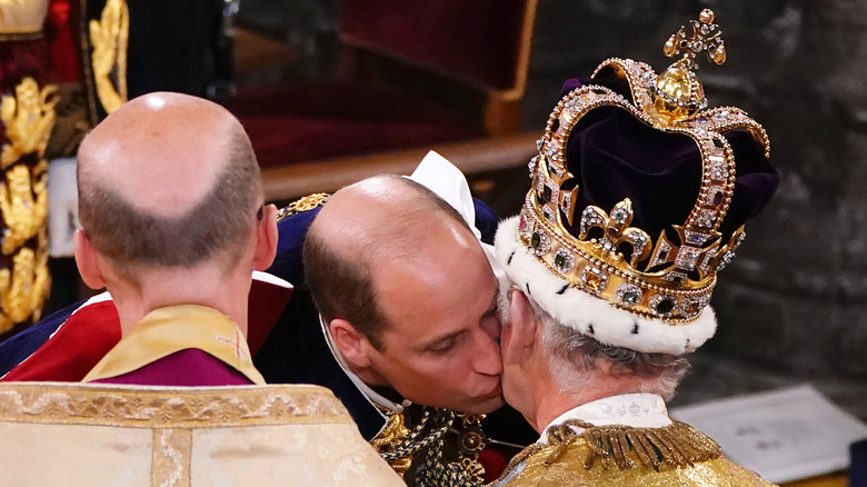 Prince William kissing King Charles III on the cheek at his coronation