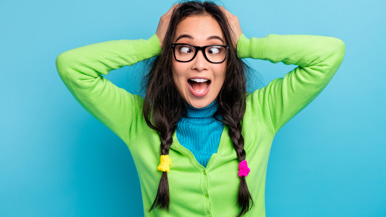 Woman messy braids crossed eyes smiling