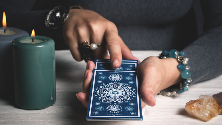 fortune teller holding tarot cards