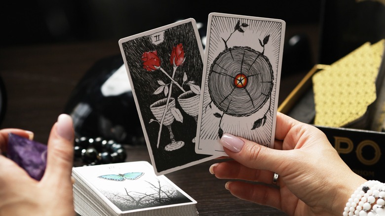 Hands holding tarot cards
