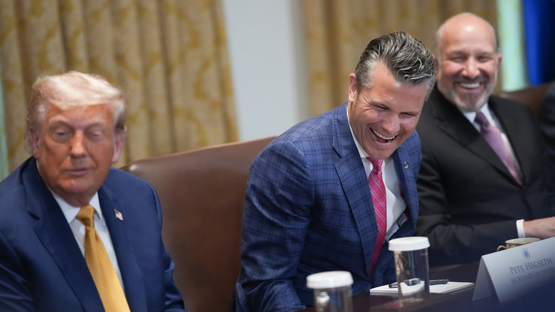President Donald Trump (L) shares a laugh with Defense Secretary Pete Hegseth (C) and Commerce Secretary Howard Lutnick (R) during a Cabinet Meeting