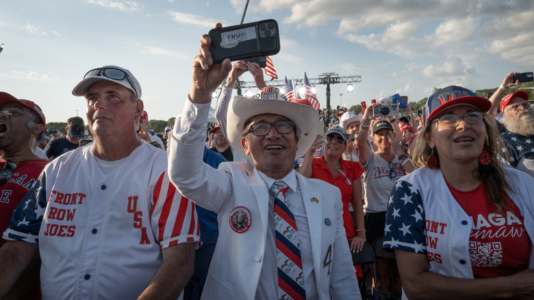 Supporters listen to U.S. President Donald Trump speak at a rally to kick off the July Fourth holiday weekend at the Iowa State Fairgrounds