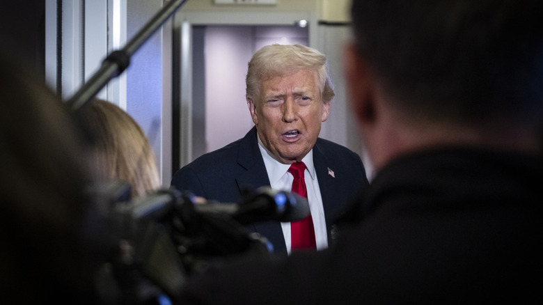 Donald Trump crowded by reporters on Air Force One