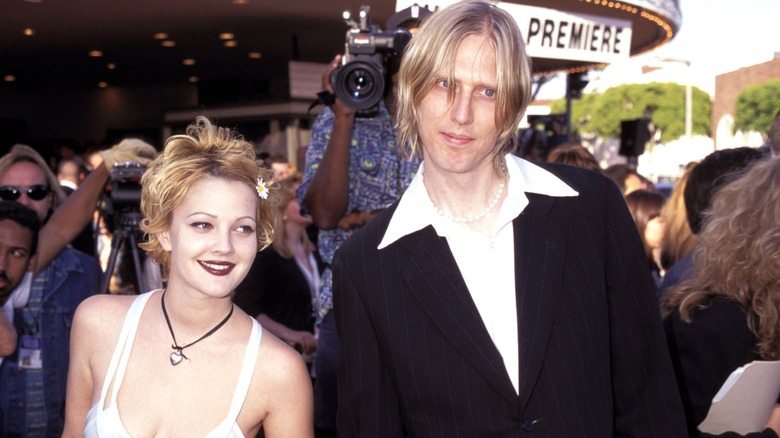 Drew Barrymore and Eric Erlandson at a movie premiere in 1995