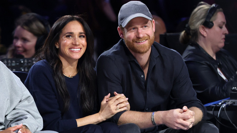 Prince Harry and Meghan, Duchess of Sussex, sitting court side at a basketball game in 2026