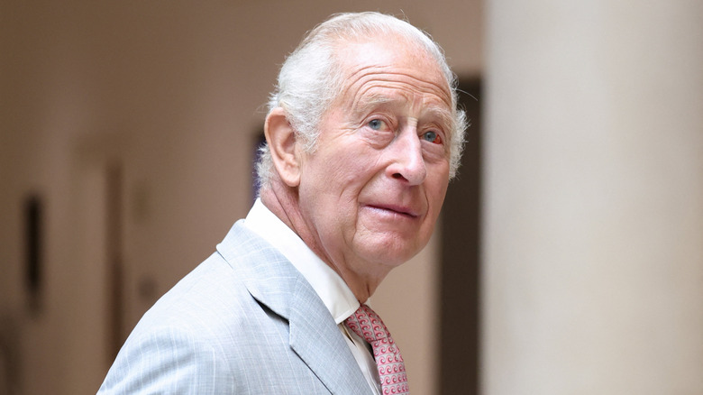 King Charles III looking over his shoulder while visiting the University of Oxford in 2026