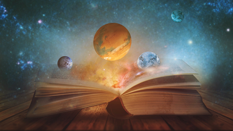 Planets of the solar system emerging from a book