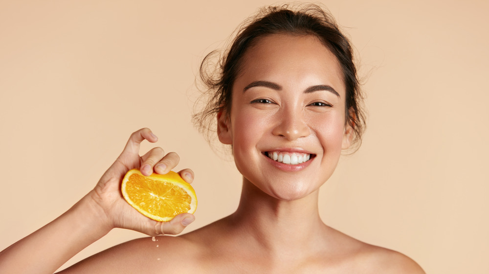 Woman holding an orange