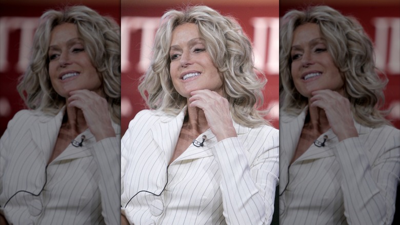 Farrah Fawcett smiling on a stage at an event in 2005