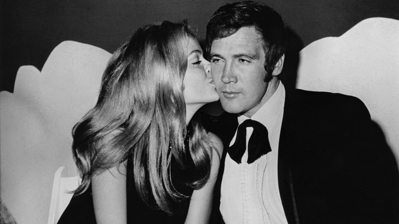 Farrah Fawcett kissing Lee Majors on the cheek in 1969