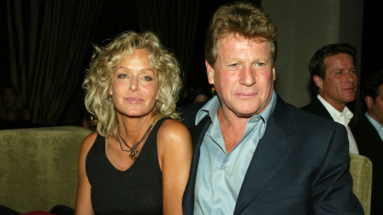 Farrah Fawcett and Ryan O'Neal sitting together at an event in 2003