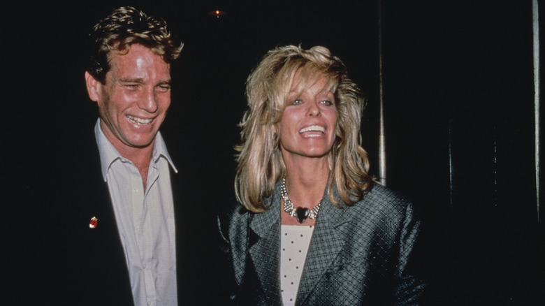Ryan O'Neal and Farrah Fawcett smiling together in 1987