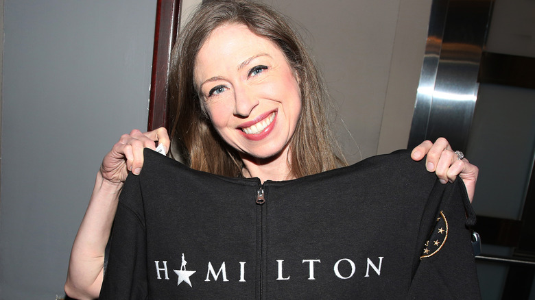 Chelsea Clinton holding a Hamilton shirt