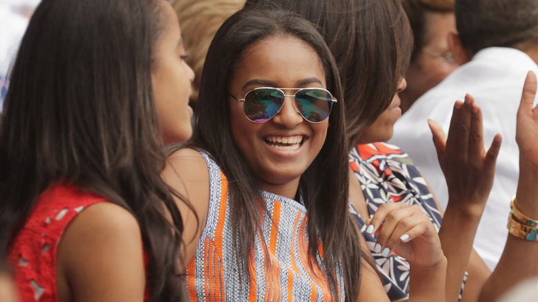 Sasha Obama chatting to Malia Obama in the stands