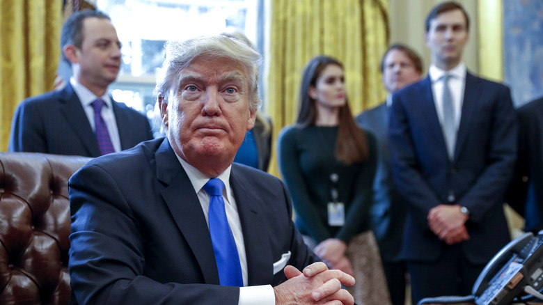 hicks in the background supporting donald trump