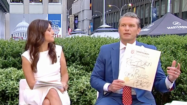 Pete Hegseth shows off his scribbled on Harvard diploma