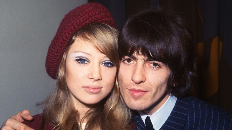 George Harrison with arm around Pattie Boyd